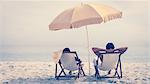 People relaxing and reclining on deck chairs