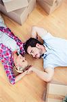 Young couple relaxing on the wooden floor