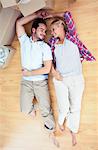 Young lovers lying on the wooden floor