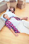 Couple relaxing together on the wooden floor