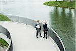 Mature businessmen standing on walkway talking, Mannheim, Germany