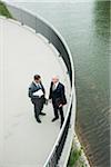 Mature businessmen standing on walkway talking, Mannheim, Germany