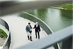 Mature businessmen on walkway talking, Mannheim, Germany