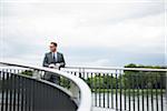 Mature businessman standing on bridge, Mannheim, Germany