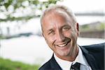 Close-up portrait of mature businessman smiling at camera