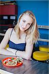 Blonde teenage girl eating tacos at Mexican restaurant in Portland Oregon.