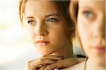 Close-up portrait of teenage girl with blurred young woman in foreground