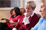 Woman looking distressed in dental office waiting area.