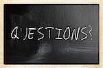 "questions" handwritten with white chalk on a blackboard