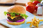 cheese burger , french fries and fast food with plenty of raw materials on the background