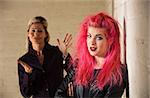 Angry mother with frustrated daughter in pink hair