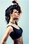 sexy brunette girl in fashion pose with creative hair-style and black top with motion blur effect