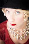 Beautiful lady with an old fashioned style shot in studio with a black background.