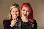 Laughing beautiful European mother and daughter indoors