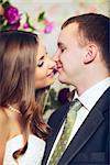 charming bride and groom kissing, close up portrait