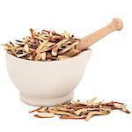 Chinese herbal medicine of licorice root in a stone mortar with pestle over white background.