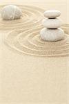 Balance of three zen stones in sand