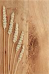 Wheat and seed on wooden oak background.