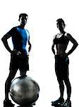 one caucasian couple man woman personal trainer coach exercising fitness ball silhouette studio isolated on white background