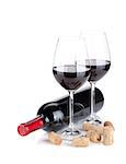 Red wine glasses, bottle and corks. Isolated on white background