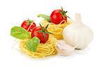 Cherry tomatoes, basil, garlic and pasta. Isolated on white background