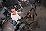 Handsome glass artisan handling glowing hot object