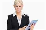 Serious businesswoman holding a tablet computer against white background