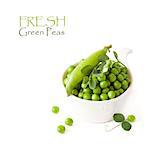 Fresh kitchen garden green peas with pod and flower in a white bowl.