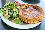 Quiche Lorraine Pasty with Mixed Green and Tomatoes Salad Closeup