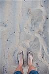 Men's feet in the sand