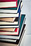 Closeup of a Very high stack of books on a table