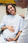 Smiling pregnant woman in wheelchair