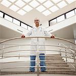 Doctor looking down from stairwell in hospital