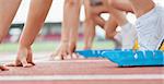 Runner waiting behind the start line ready to run at starting blocks