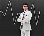 Businessman with arms crossed standing in front of a statistic