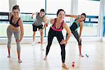 Happy people in aerobics class in fitness studio