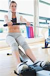 Woman on the rowing machine in fitness studio