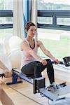 Woman rowing at the gym