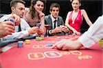 People playing exciting game of poker in casino