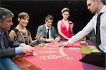 Woman looking up from poker game and smiling in casino