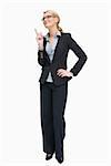 Smiling businesswoman standing and thinking while pointing up