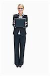 Smiling businesswoman standing while holding tablet pc