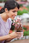 Woman holding a flower and smelling on the flower