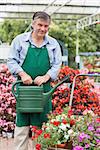 Man holding a watering can in garden center