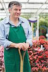 Man holding a spade in garden center