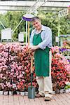 Employee holding spade in garden center