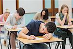 Man sleeping during exam in exam hall