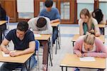 Students sitting a test in an exam hall in college