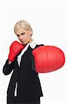 Serious woman with red gloves fighting against white background