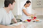 Wife preparing lunch for husband at home in kitchen